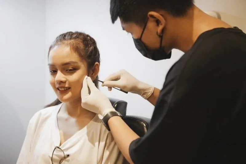 Mộng thấy nhiều người xem bạn bấm lỗ tai 